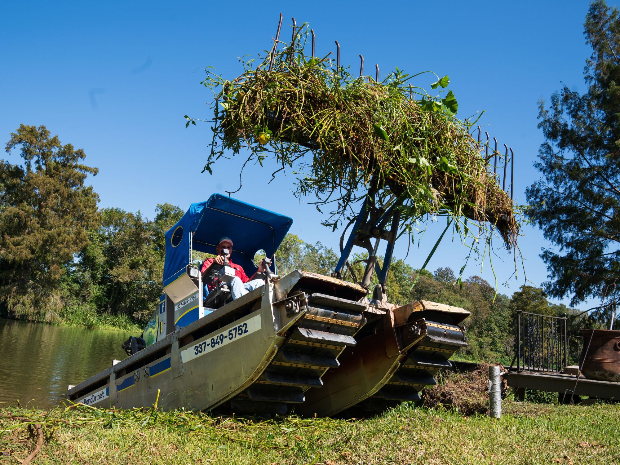 Truxor with Reed Rake attachment removing vegetation